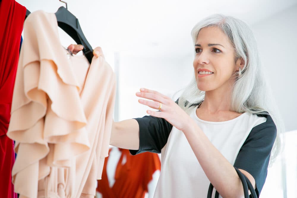 Apparel being sorted on a boutique rack.