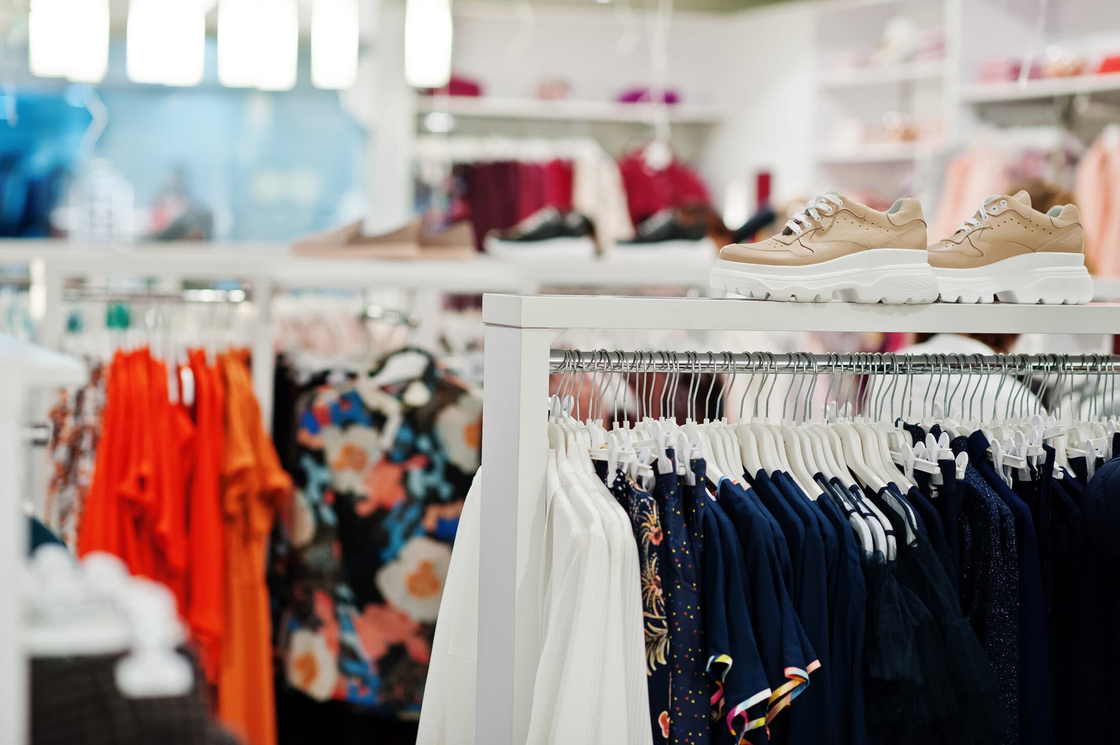 Independent retail store interior with clean shelving and clothing racks.